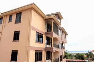 a building with balconies on the side of it at Kingram Apartments in Entebbe