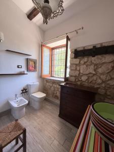 a bathroom with a white toilet and a sink at Asparano in Ognina +34 photos
