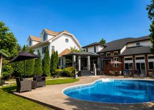 a house with a swimming pool in the yard at Windsor Luxury Oasis in Windsor