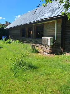 an old house with a air conditioner on the porch at Cozy and spacious accommodation with a sauna in Tartu! in Tartu +10 photos