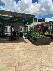 two people sitting on a bench under a building at GCurtway Homes Tsavo Superior Studios in Nairobi +9 photos