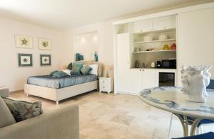 a bedroom with a bed and a table in a room at Marina Homes Sea View Ortigia in Syracuse