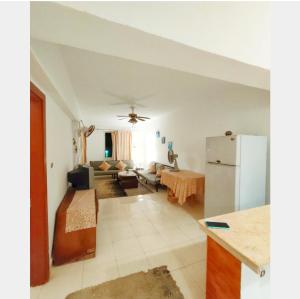 a kitchen and a living room with a refrigerator at Full board rent in Ras Sedr +3 photos