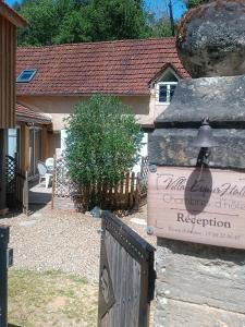 a house with a gate and a sign in front of it at Villa EsquirHall, chambres d'hôtes in Journiac +54 photos