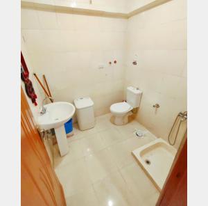 a bathroom with a sink and a toilet and a tub at Full board rent in Ras Sedr