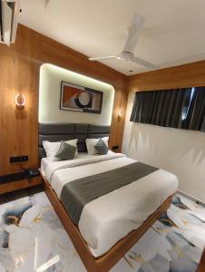 a bedroom with a large bed in a room at Hotel Promince Icon in Ahmedabad