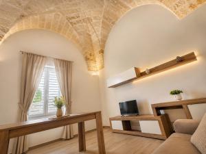 a living room with a couch and a tv at Palazzo Solera in Casarano