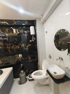 a bathroom with a toilet and a sink at Hotel Promince Icon in Ahmedabad