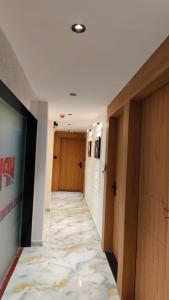 a hallway with doors and a rug on the floor at Hotel Promince Icon in Ahmedabad