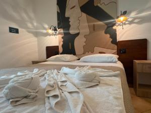 a bedroom with two beds with towels on them at Vistamare - Bed & Breakfast in Alliste +23 photos