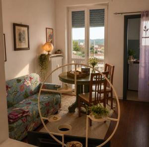 a living room with a table and a couch at Matteotti suite&gare in Asti