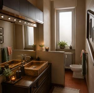 a bathroom with a large wooden sink and a toilet at Matteotti suite&gare in Asti +12 photos