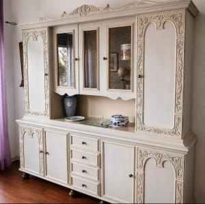 a large white cabinet with mirrors on it at Matteotti suite&gare in Asti