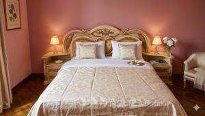 a bedroom with a large white bed with two tables at Elkasa guest house in Zvartnots International Airport