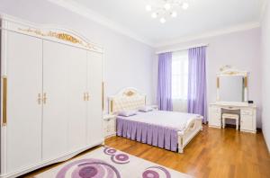 a white bedroom with a bed and a mirror at Elkasa guest house in Zvartnots International Airport