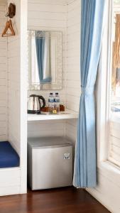 a kitchen with a counter with a sink and a window at Tawe Ocean Blue Villa Lembongan in Nusa Lembongan +44 photos