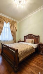 a bedroom with a large bed and a chandelier at Elkasa guest house in Zvartnots International Airport