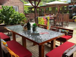 a table with a television on a patio at Coffee Mama Stay in Paramaribo +1 photo