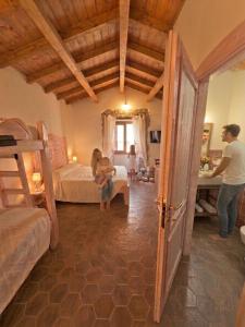 a man standing in a room with a bedroom at Regnos Altos boutique rooms in Bosa
