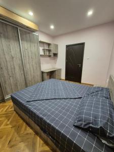 a bedroom with a large bed in a room at Апартамент riverside in Yambol