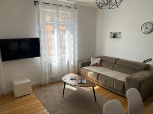 a living room with a couch and a table at BELISAMA in Molsheim