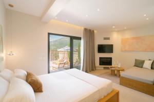 a hotel room with a bed and a balcony at Atman Eco Lodge in Gliki