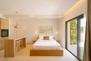 a bedroom with a bed and a desk and a kitchen at Atman Eco Lodge in Gliki +76 photos