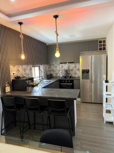 a kitchen with a large island with bar stools at Appart Angel in Espargos