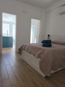 a bedroom with a bed with a blue pillow on it at La Terrazza dell'Abate in Maiori
