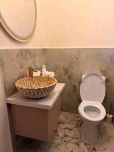 a bathroom with a toilet and a sink with a mirror at Guesthouse Bârlogul Balaurului in Afumaţi +6 photos