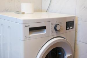 a white washer and dryer in a room at Apartments Jurina in Krk