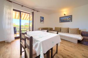 a living room with a table and a couch at Apartments Jurina in Krk