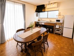 a kitchen and dining room with a table and chairs at Joynest TAKAMATSU in Takamatsu