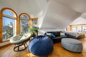 a living room with a couch and a bed at Havre sur la Baie in Baie-Saint-Paul +22 photos