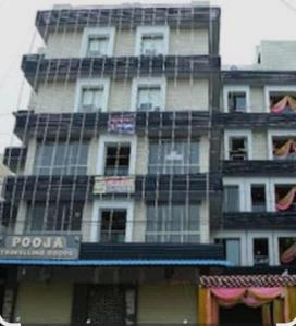 a tall building with scaffolding on the side of it at Hotel Tirumala in Secunderabad