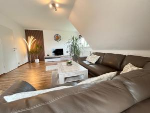 a living room with a couch and a table at Ferienwohnung Balkon Grupe in Stadtoldendorf