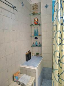 a bathroom with a shower with a bench and shelves at nikola's house in Adamantas +36 photos