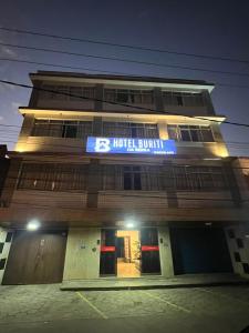 a hotel building with a blue sign on it at Hotel Buriti da Serra in Itaipava