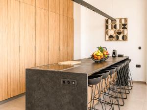 a kitchen with a counter with a bowl of fruit on it at Miguel Luxury Beach Front Villa in Fánai