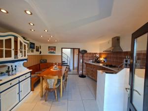 a kitchen with a wooden table and a dining room at Milla Sky in Varaždinske Toplice