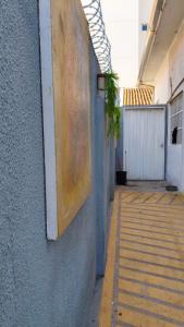 an empty hallway of a building with a plant at Nomah Hostel in Sao Jose do Rio Preto