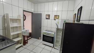 a kitchen with a stove and a sink in it at Nomah Hostel in Sao Jose do Rio Preto