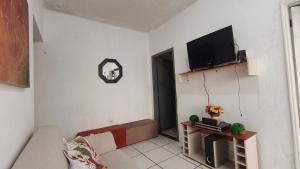 a living room with a couch and a flat screen tv at Nomah Hostel in Sao Jose do Rio Preto