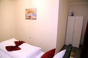 a room with a bed and a painting on the wall at City Apartman 103 in Bosanski Brod