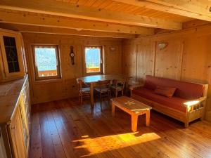 a living room with a couch and a table in a cabin at Ceda Fiore in Costalta