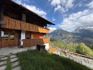 a building on a hill with mountains in the background at Ceda Fiore in Costalta