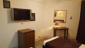 a hotel room with a flat screen tv on the wall at New Sandy Hotel in Marsa Matruh