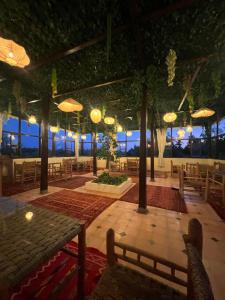 a large room with tables and chairs and umbrellas at Oloft in Marrakesh