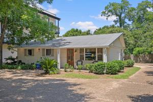 a small white house with a gray roof at Downtown Fairhope Cottage in Fairhope
