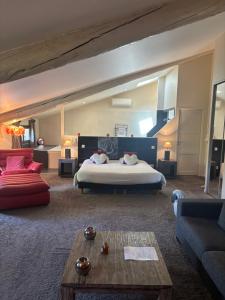 a large room with a bed and a couch at Au Lavoir in Colombiers